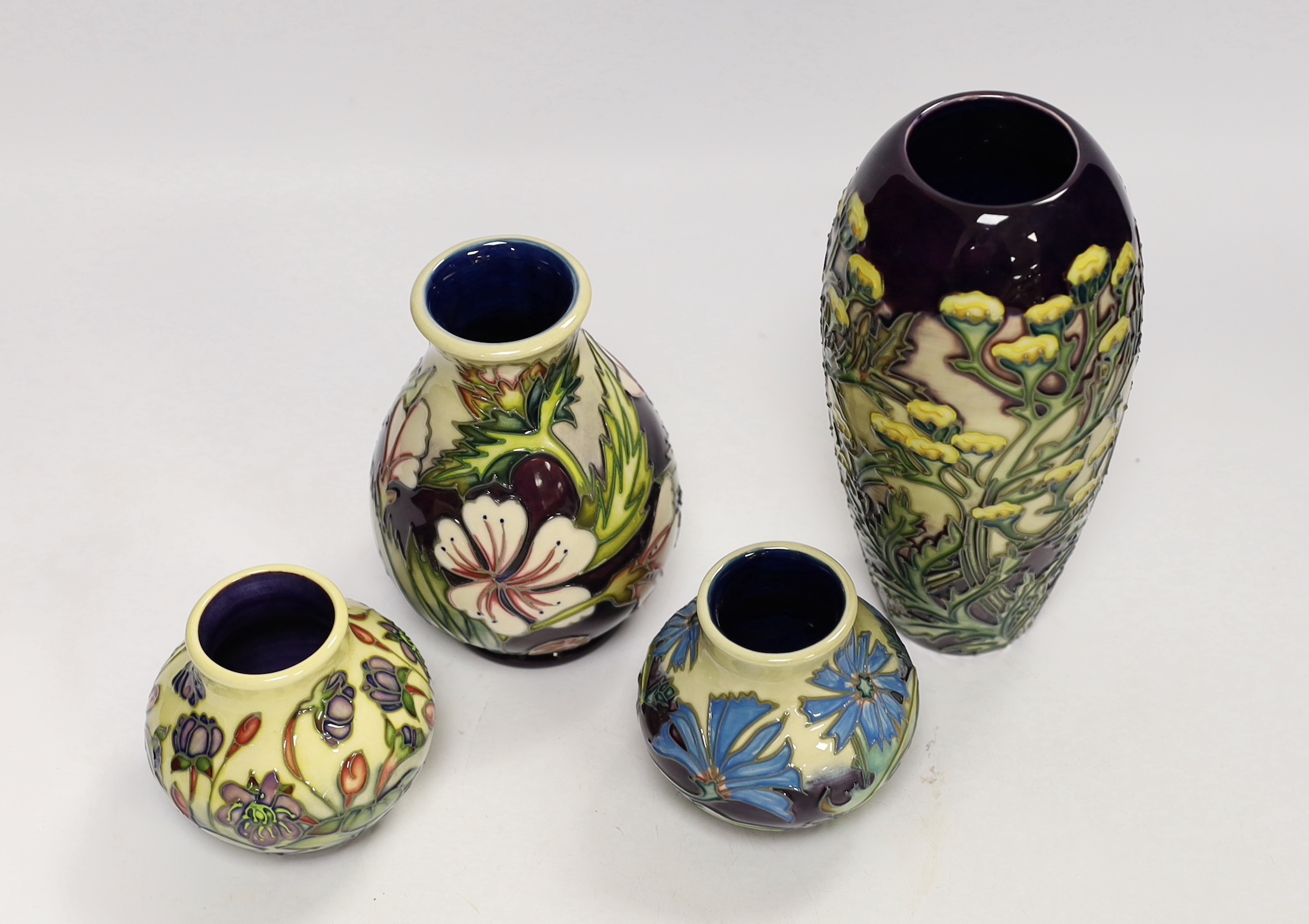 Two squat Moorcroft vases and two larger vases, tallest 19cm high